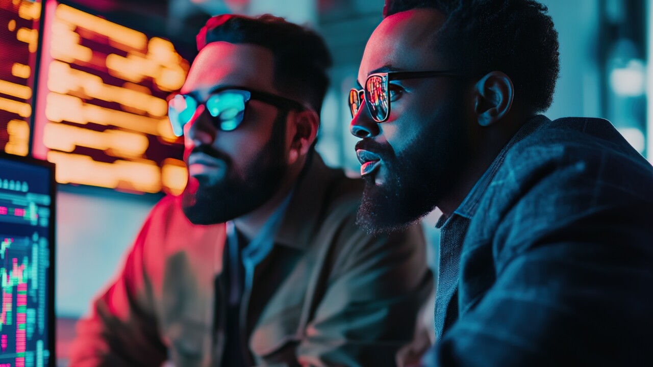 Two diverse crypto traders brokers stock exchange market investors discussing trading charts research reports growth using pc computer looking at screen analyzing invest strategy, financial risks.